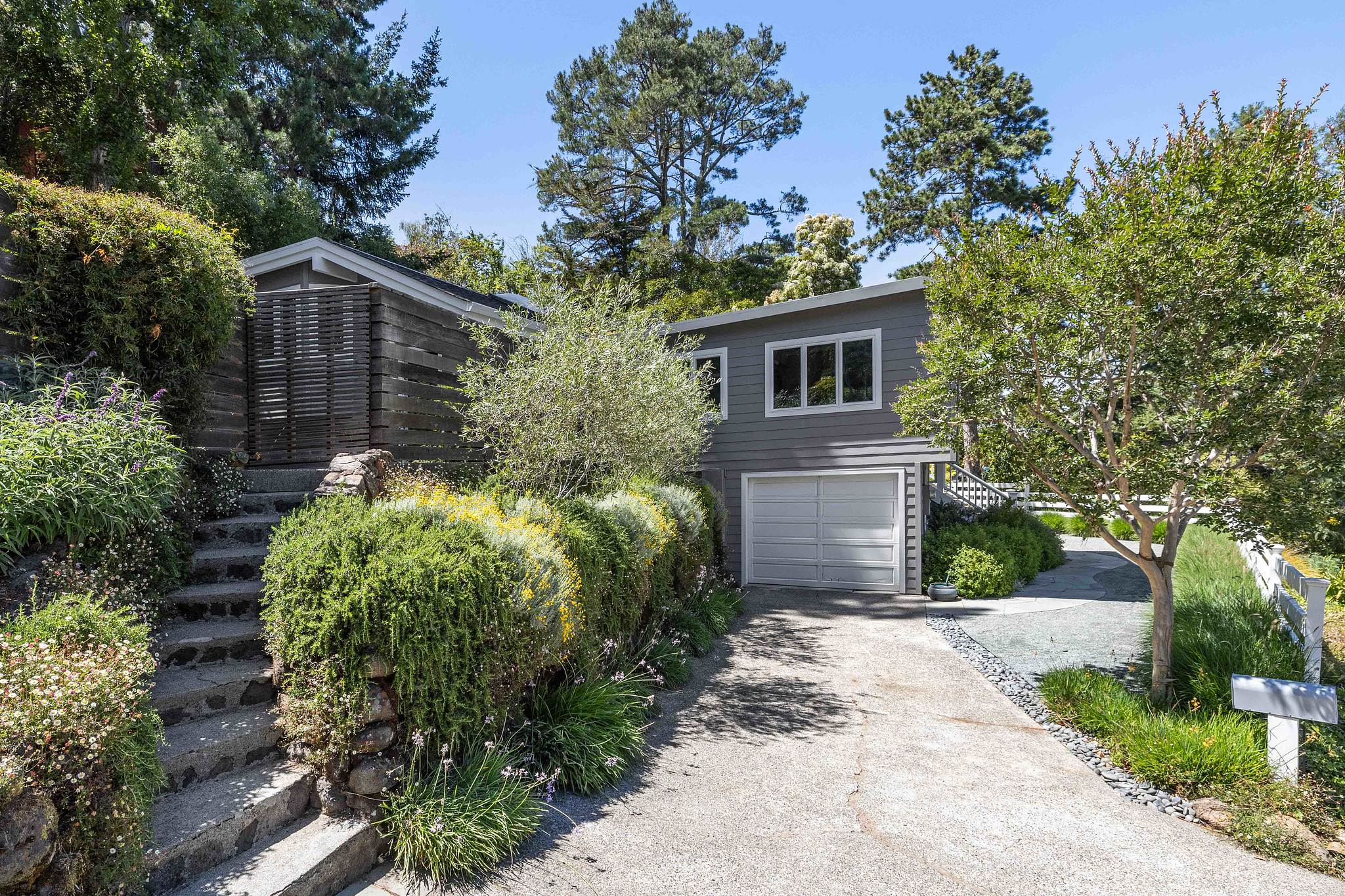 Front exterior view of 473 Montecito Drive, Corte Madera, showing a home with grey facade