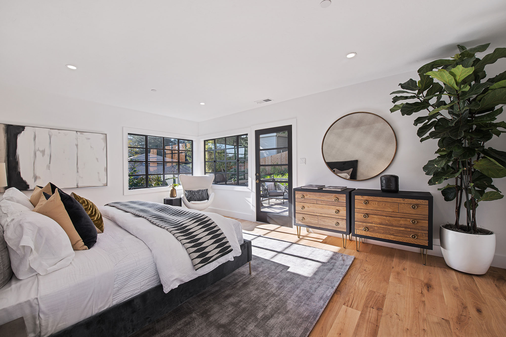 Primary bedroom with wood floors and en-suite bath