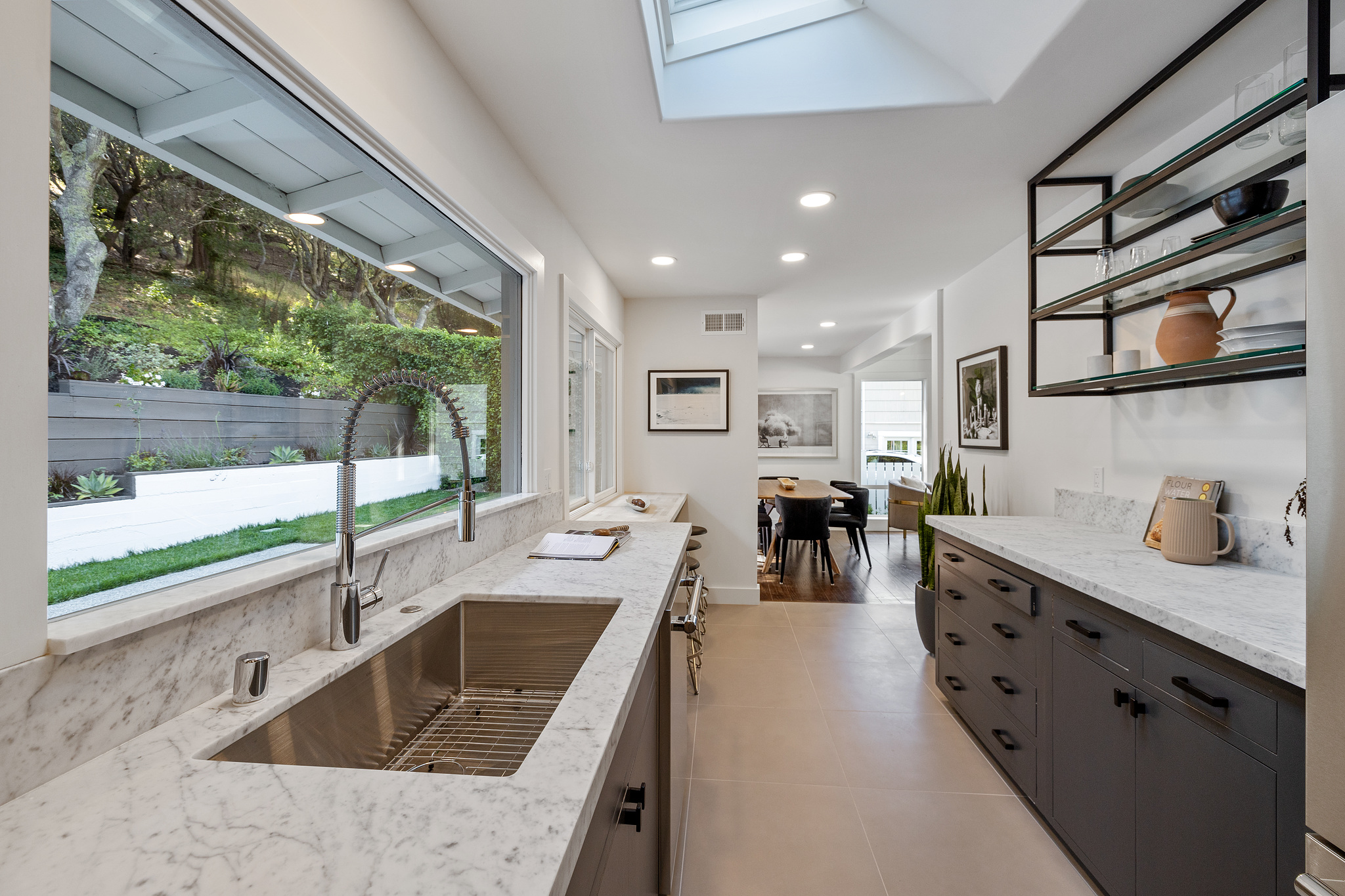 View of the kitchen, showing a galley style kitchen with skylight