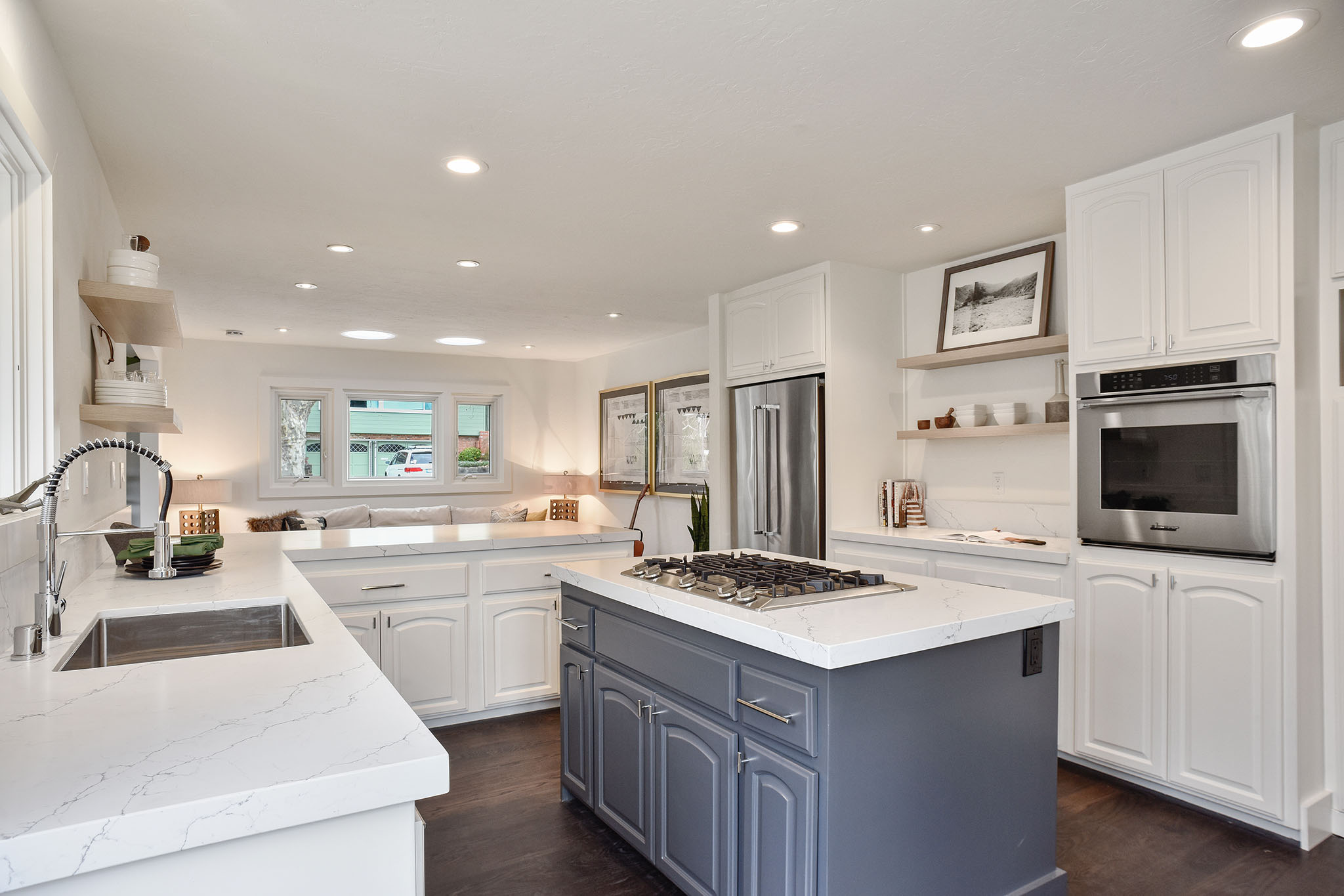 Kitchen showing light cabinetry and an open floor plan