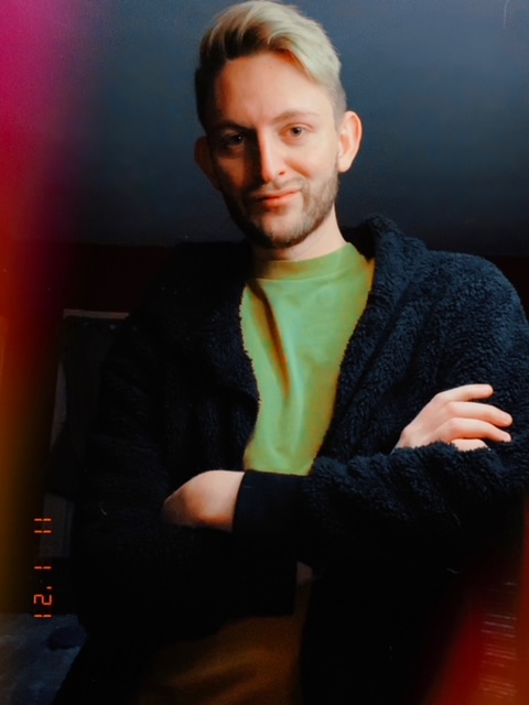 Photo of young man in a green shirt