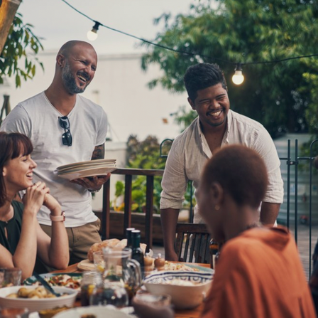 People laughing and eating outside