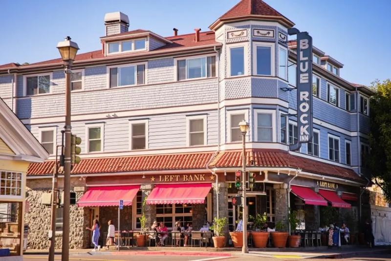 Exterior view of the Blue Rock Inn in Larkspur, CA, showing a three story building with awnings 