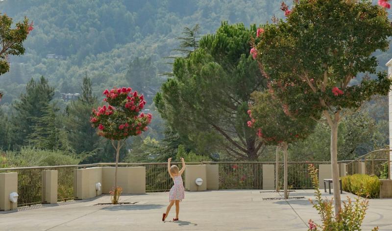 View of a child dancing in an outdoor area in San Anselmo