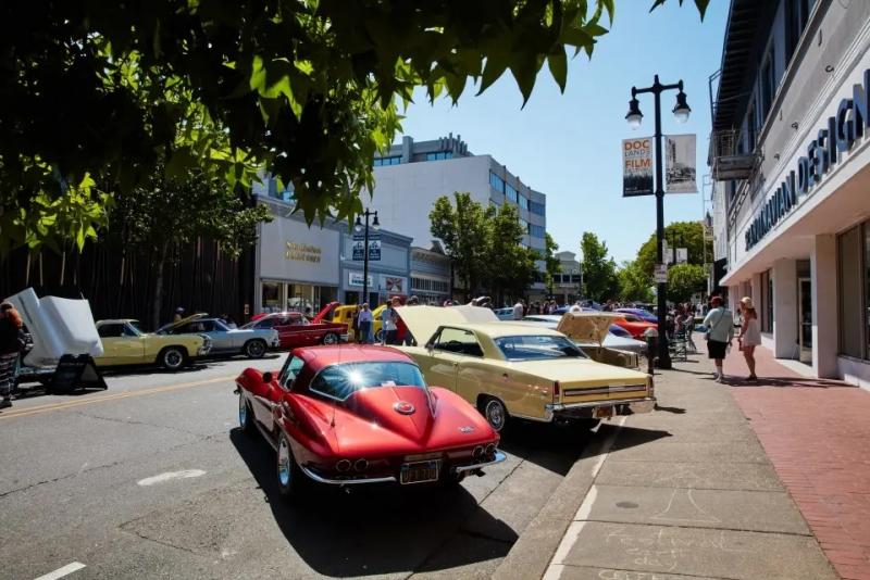 Street view of San Rafael showing a street lined with shops and people enjoying a car show