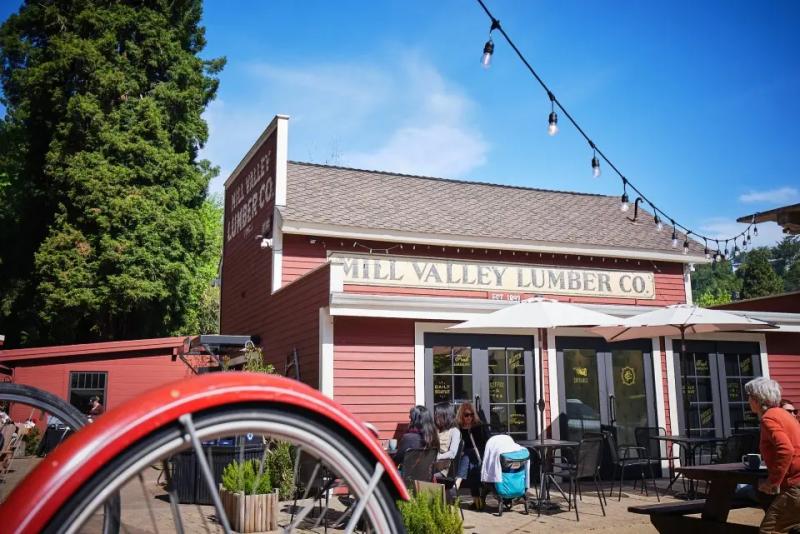 View of a red barn with a sign for Mill Valley Lumber Co.