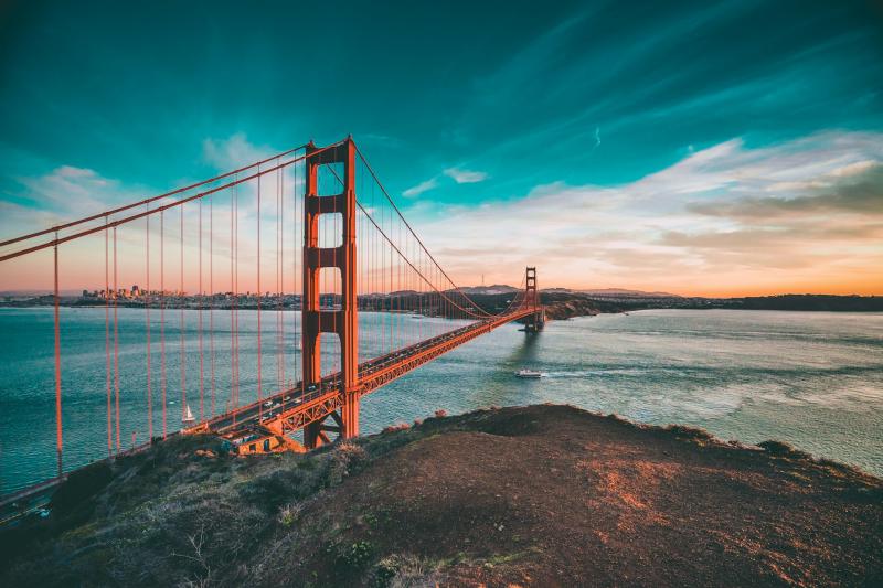 View of the Golden Gate Bridge at twilight, showing San Francisco in the distance