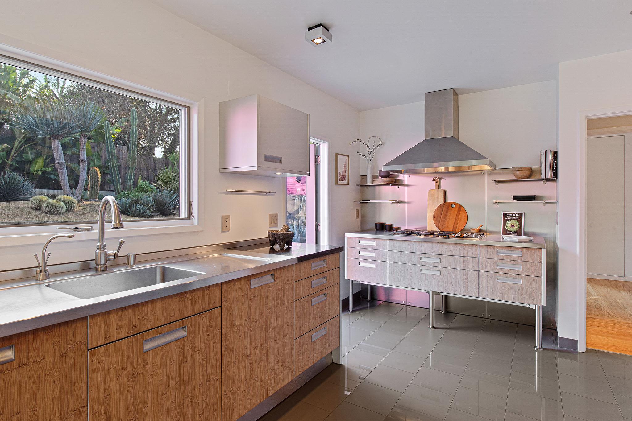 View of the cooking area and chefs kitchen, featuring wood cabinets  #12