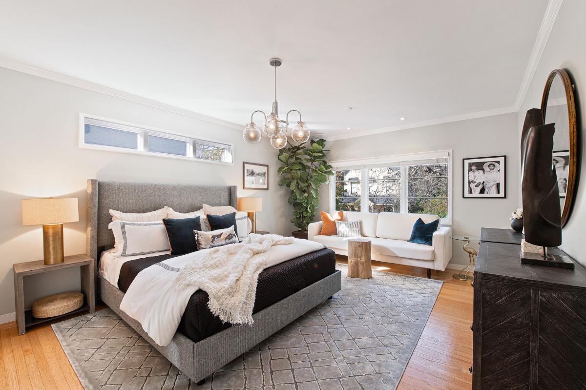 Primary bedroom with large windows and wood floors #14