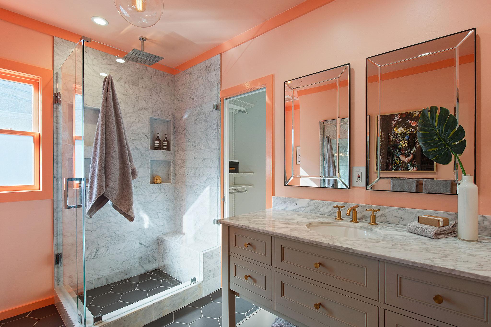 Bathroom with brightly colored walls, a vanity and glass shower #15