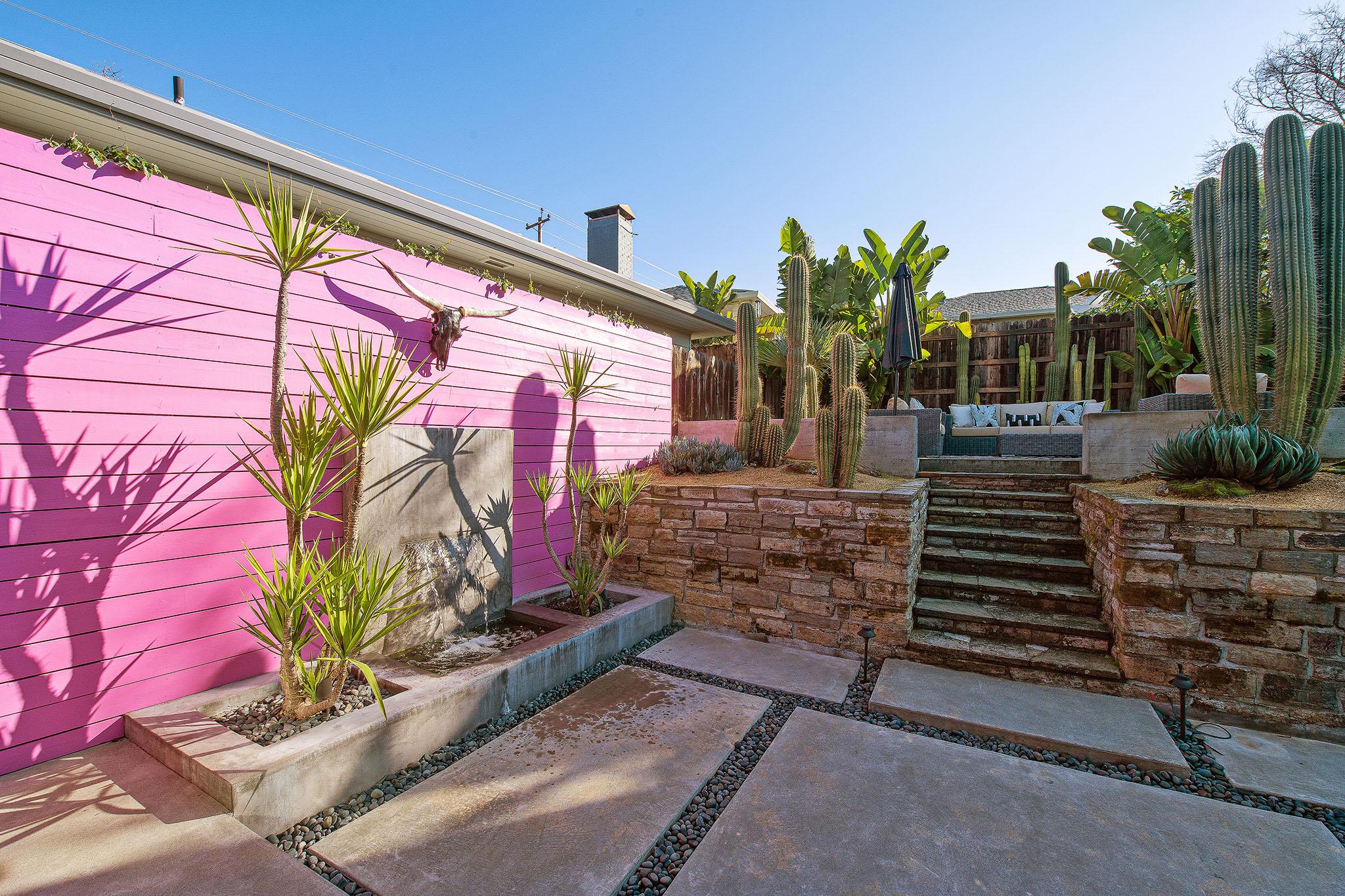 View of the outdoor living area showing a pink accent wall #16