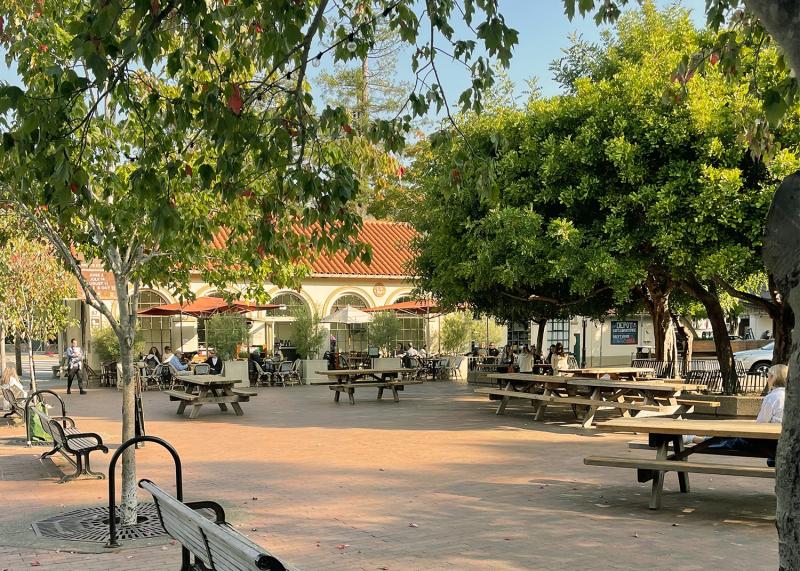 View of the Depot, an outdoor gathering area in Mill Valley, showing various people sitting outside