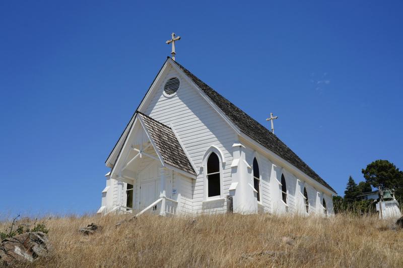View of a small wooden church on a hill 